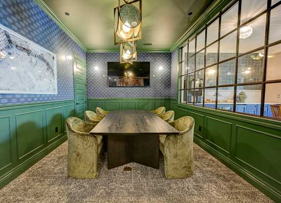 A dining room with a wooden table and chairs.