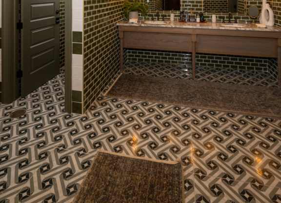 A bathroom with a black and white tiled floor.