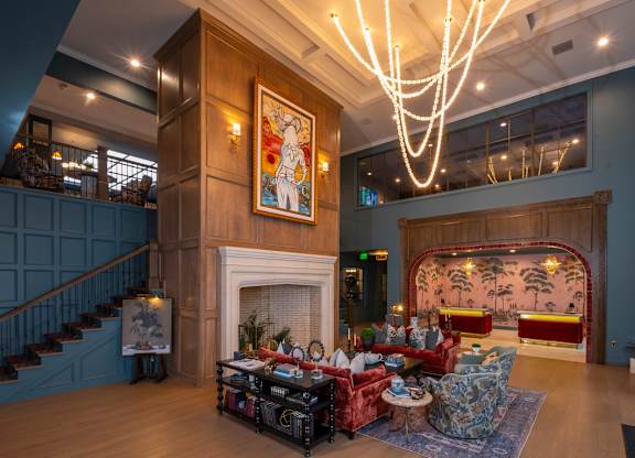 A large room with a fireplace and a painting on the wall.