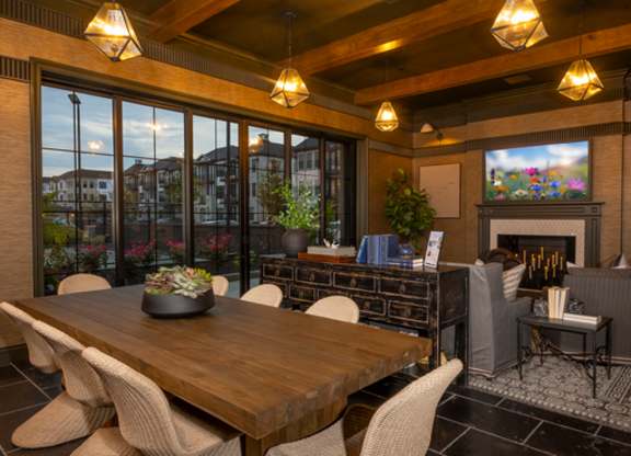 A modern dining room with a wooden table and chairs.