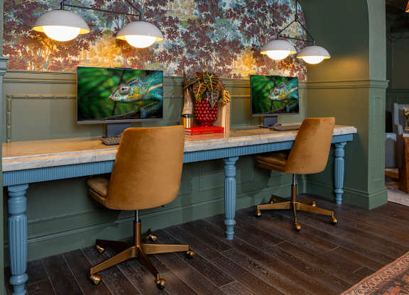 A room with a desk and two chairs.