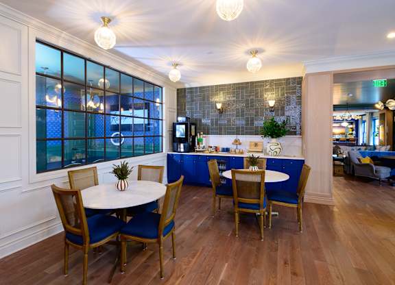 A dining room with a table set for four.