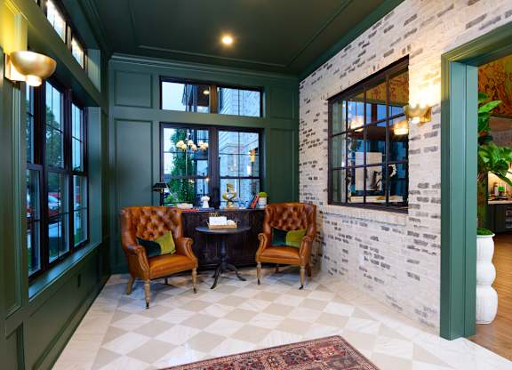 A room with a table and chairs in the middle of it.