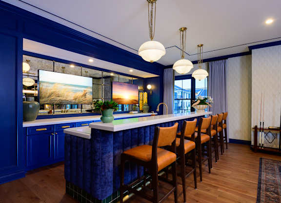 A kitchen with blue cabinets and a white countertop.