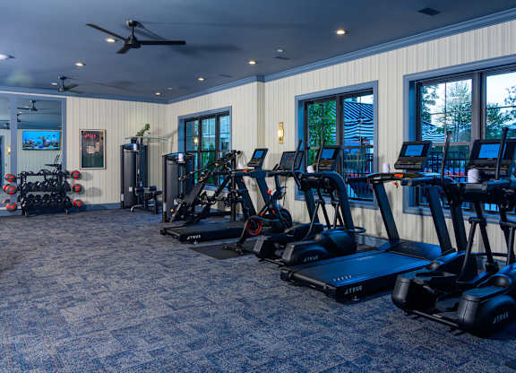 Fitness center with cardio equipment and weights at Fairmont Apartments, Westerville, Ohio
