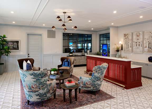 Elegant lobby with red reception desk and seating at Fairmont Apartments, Ohio