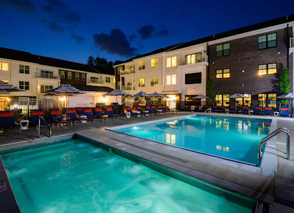Evening pool area with spa and sundeck seating at Fairmont Apartments, Ohio, 43081