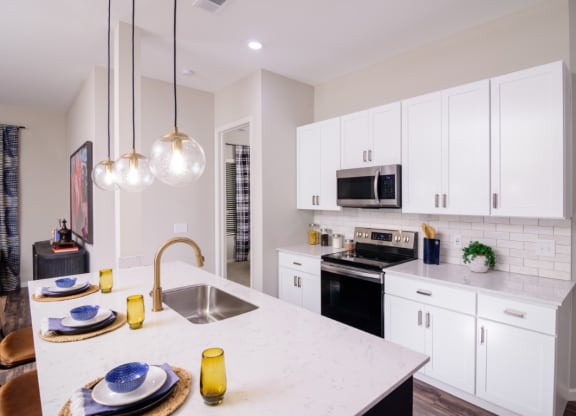 a kitchen with white cabinets and a white counter top at Essex, Columbus, OH