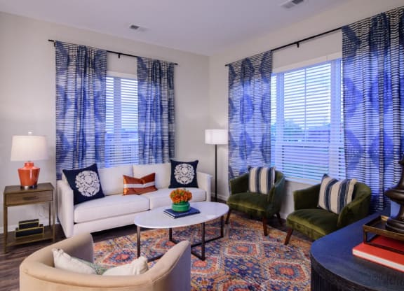 a living room with couches chairs and a table at Essex, Columbus