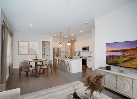 an open living room and kitchen area with a dining table and chairs and a flat screen tv at Fairfax, Grandview, OH, 43212