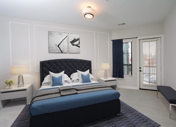 a bedroom with a bed and a door leading to a balcony at Fairfax, Grandview, OH, 43212
