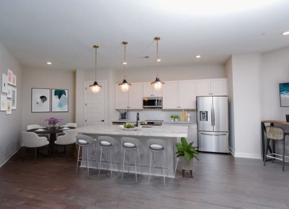 a kitchen with a large center island next to a dining room at Fairfax, Grandview, Ohio