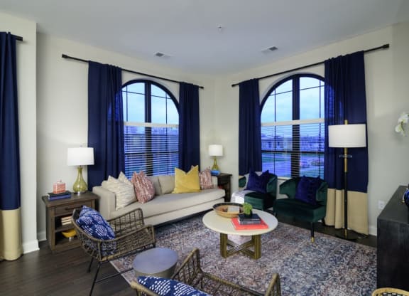 a living room with large windows and a couch and chairs at Fairfax, Ohio, 43212
