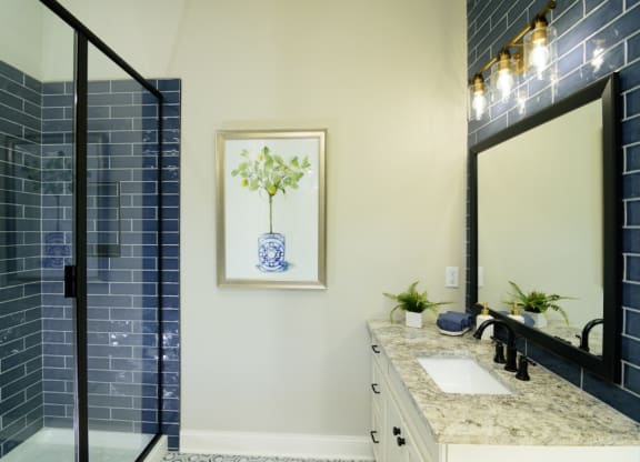a bathroom with blue subway tile and a blue and white vase on the wall at Fairfax, Grandview, OH
