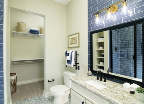 a bathroom with blue tile and a white toilet at Fairfax, Ohio