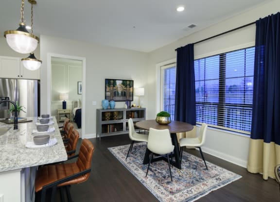 a kitchen and dining room area with a table and chairs and a large window at Fairfax, Grandview, 43212