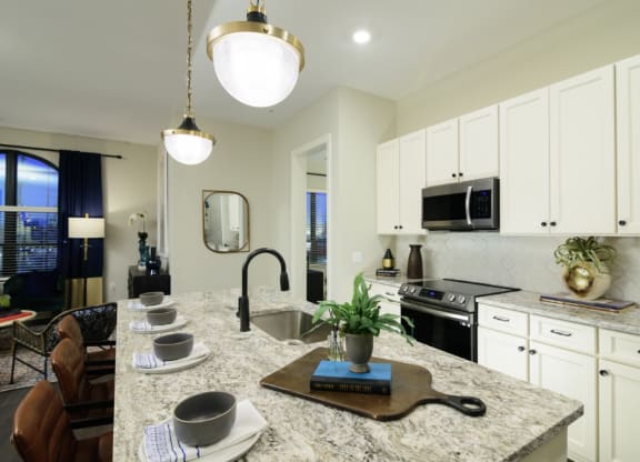a kitchen with white cabinets and granite countertops at Fairfax, Grandview, OH, 43212