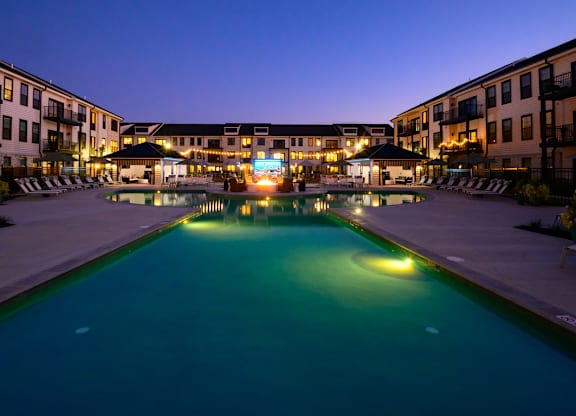 A swimming pool in a resort at night.