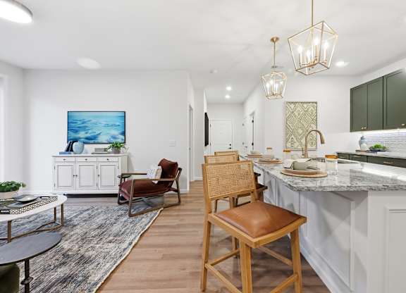 A kitchen with a bar stool in the middle of the room.