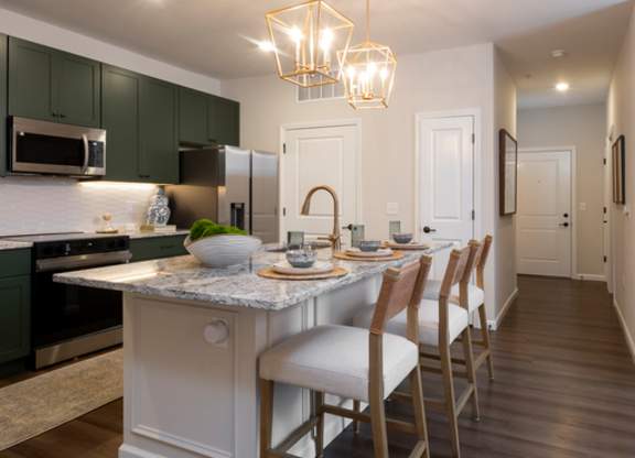 A kitchen with a table and chairs.