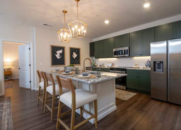 A kitchen with a table and chairs.