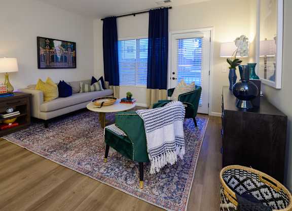 A living room with a couch, chair, and rug. at Fairmont Apartments, Westerville