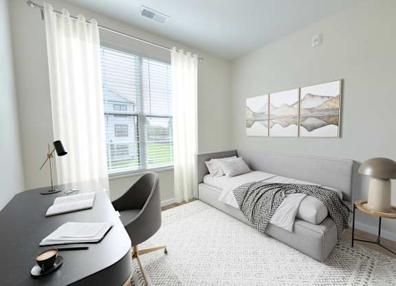 A bedroom with a bed, chair, and desk.