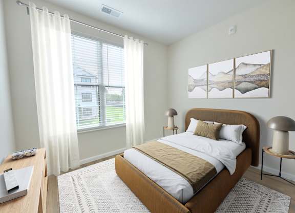 A bedroom with a large bed and a painting on the wall.