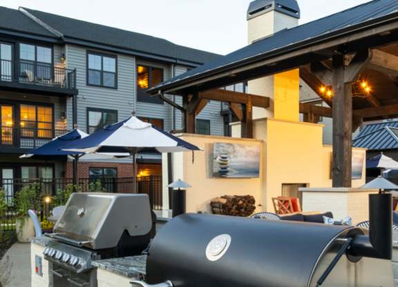 A black grill is in front of a building.