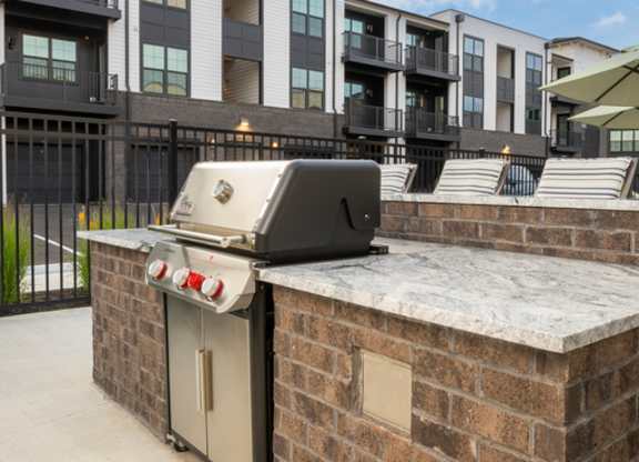 A brick wall with a dishwasher on top of it.