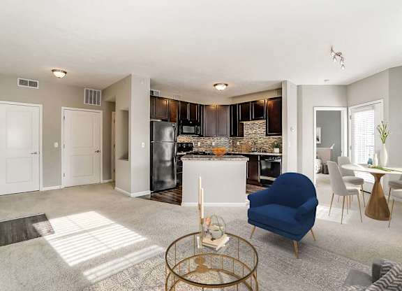 A modern kitchen with a blue chair in the foreground.