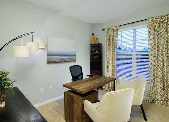 A dining room with a wooden table and chairs.