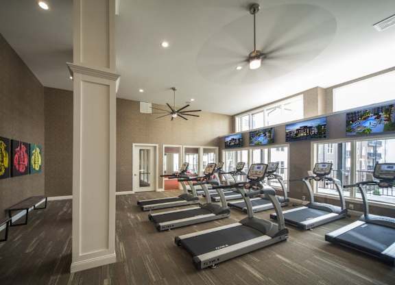 A gym with treadmills and exercise bikes.