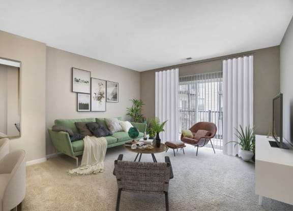 the living room of an apartment with a green couch and chairsat Taylor House Apartments, Columbus, OH