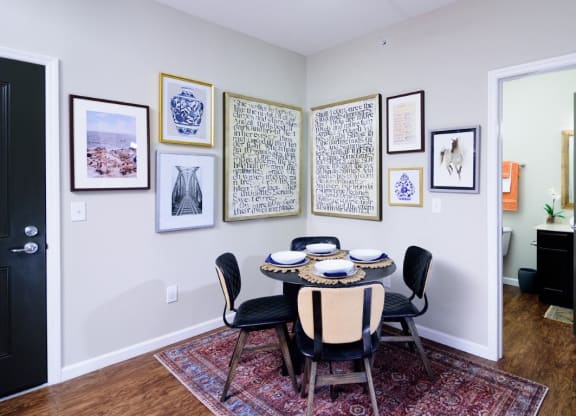 a dining room with a table and chairs and pictures on the wall at Taylor House Apartments, Columbus, Ohio