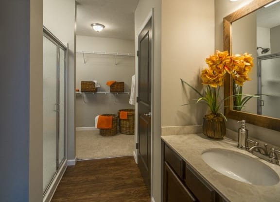 a bathroom with a sink and a shower and a mirrorat Taylor House Apartments, Columbus, OH