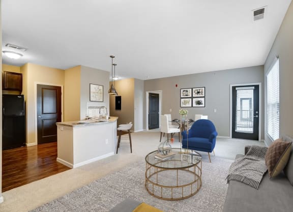 a living room and kitchen with a couch and a tableat Taylor House Apartments, Columbus, Ohio
