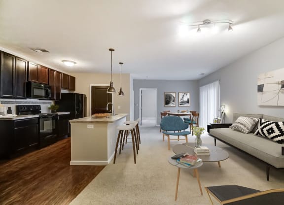 a living room with a couch and a kitchenat Taylor House Apartments, Ohio, 43214
