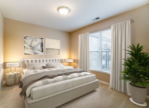 a bedroom with a bed and a potted plantat Taylor House Apartments, Columbus, OH