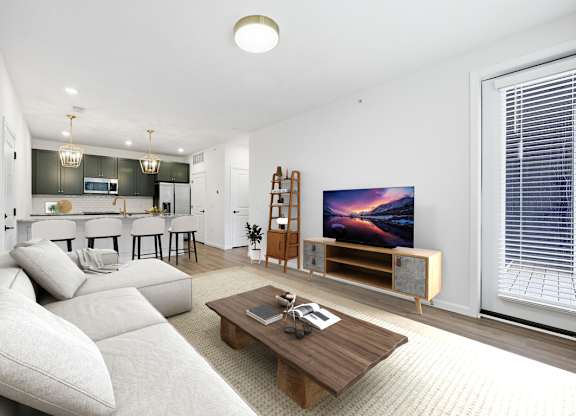 A modern living room with a large couch and a flat screen TV.
