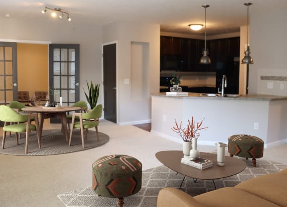 a living room and kitchen with a table and chairs