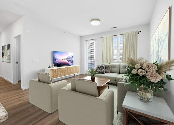 A living room with a couch, a chair, a coffee table, and a television.