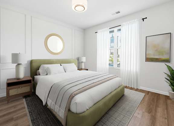 A bedroom with a large bed and a round mirror on the wall.