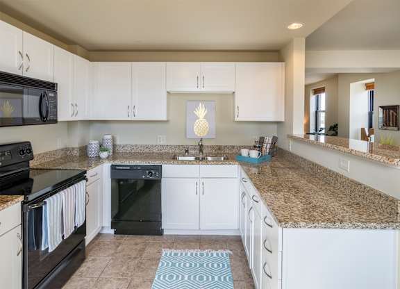 a large kitchen with stainless steel appliances and granite counter tops at Grand Wisconsin, Milwaukee, Wisconsin