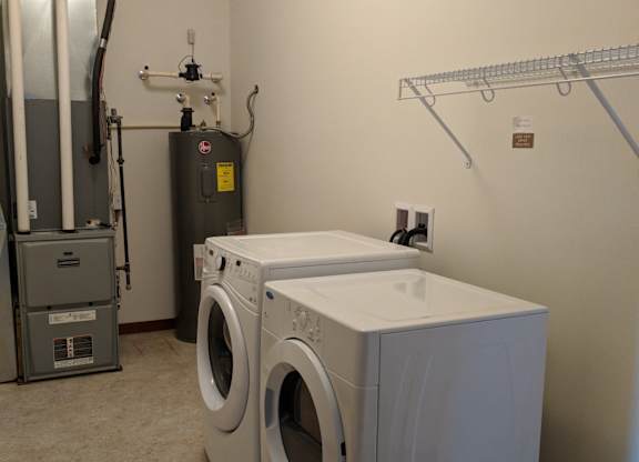 A laundry room with a washer and dryer at Cornerstone & Ravenna* Apartments, Wisconsin