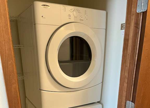 A white washing machine and dryer stacked on top of each other at Cornerstone & Ravenna* Apartments, Shorewood 53211