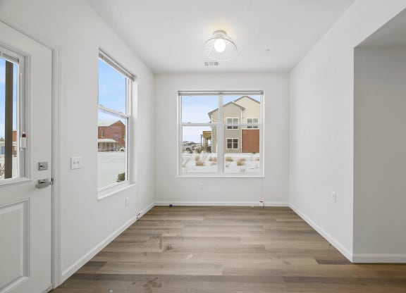 a living room with a large window and a door