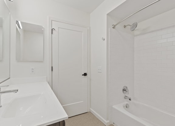 a bathroom with a sink and a tub and a shower