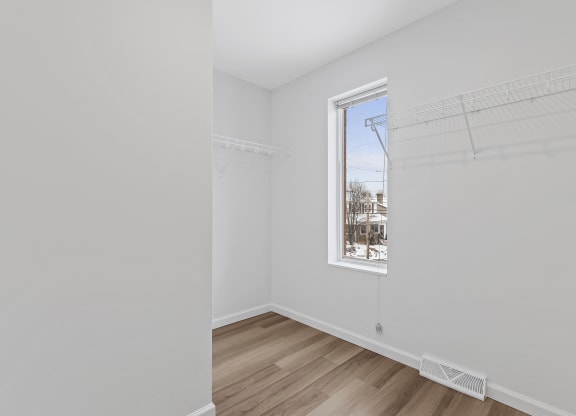 a room with white walls and a window
