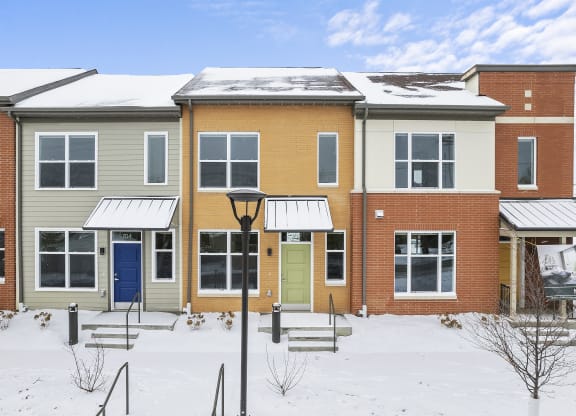 a row of houses in the snow
